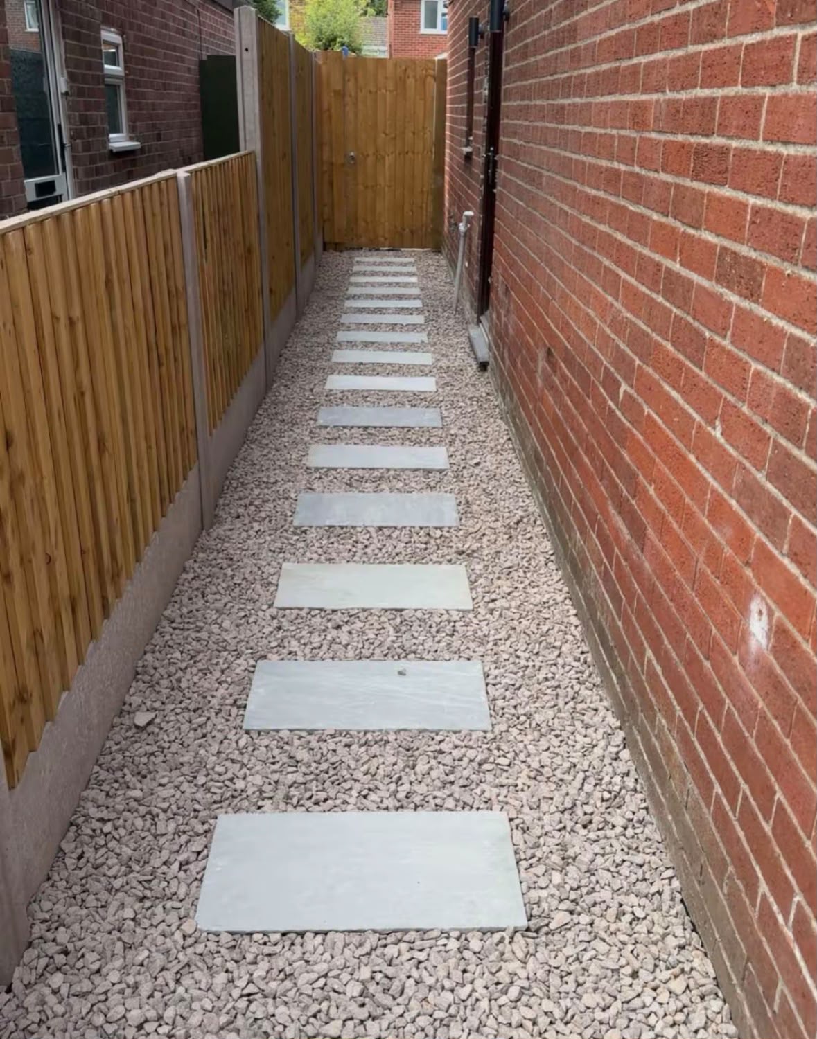 Stepping-stone path with gravel and new fencing